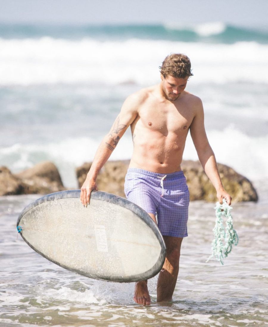 Surfer with ocean plastic in hand